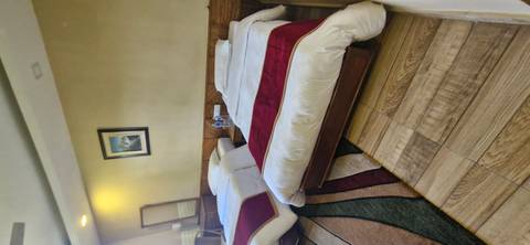       Room with two beds in a hotel or guesthouse.
  