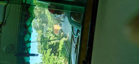       View from inside a vehicle on a road trip through a forested area.
  