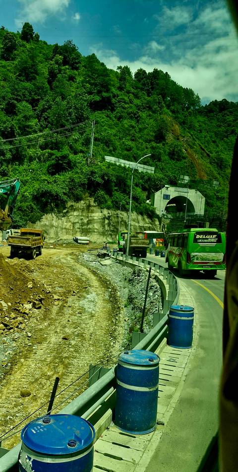 Construction area with tunnel and buses.