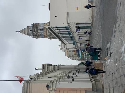       Street view with colonial architecture and a clock tower.
  