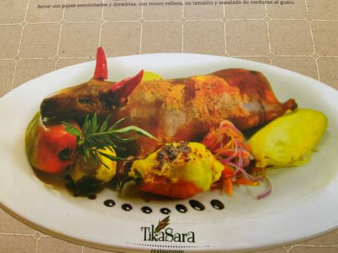       Traditional dish featuring stuffed guinea pig and sides.
  