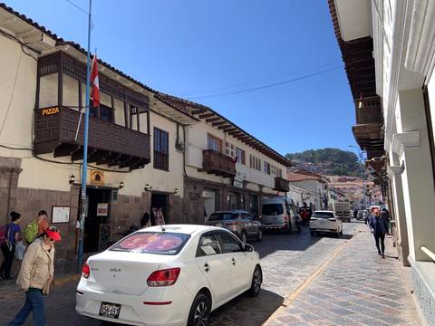       Street with traditional buildings and people walking.
  