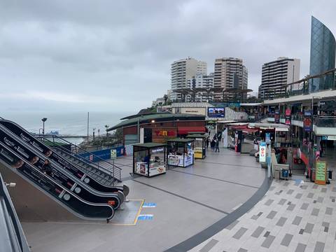       Modern shopping area by the coast with ocean view.
  