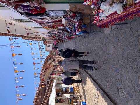       Colorful market street with people browsing.
  