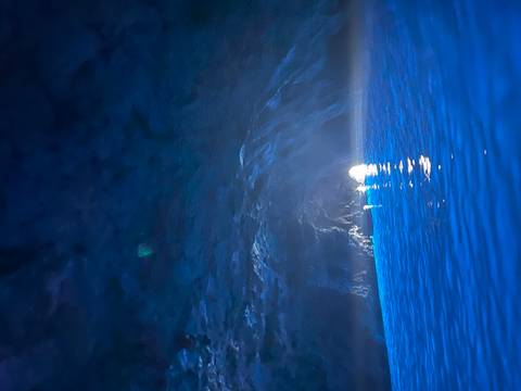       Light entering through the opening of a dark cave.
  