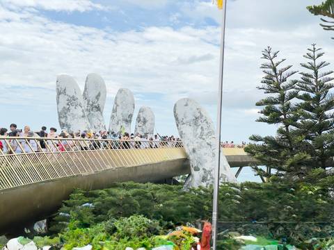 Unique bridge in the shape of hands holding it up.