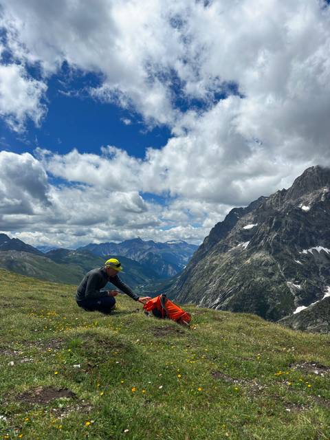 Person with backpack in a mountainous landscape.