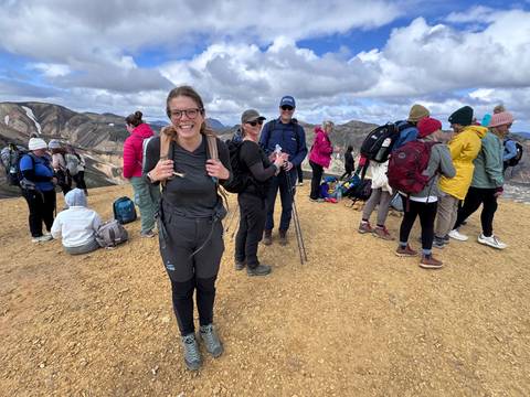 Group of hikers on a colorful mountainous terrain.