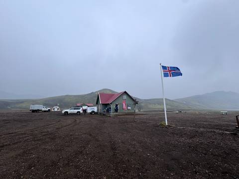Building with an Icelandic flag in a misty landscape.