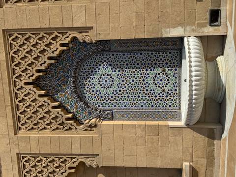       Decorative wall with intricate tile patterns.
  