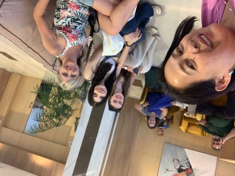 Several people relaxing in a lounge area, sitting and smiling at the camera.