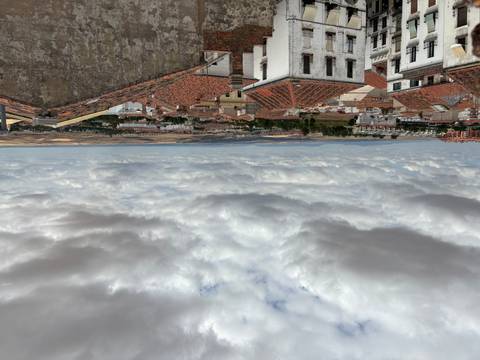      A panoramic view of rooftops in a town extending into the countryside.
  