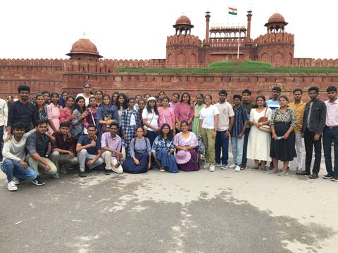 Group of people posing in front of a historical fort.