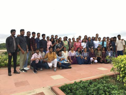 Large group of people posing for a photo outdoors.