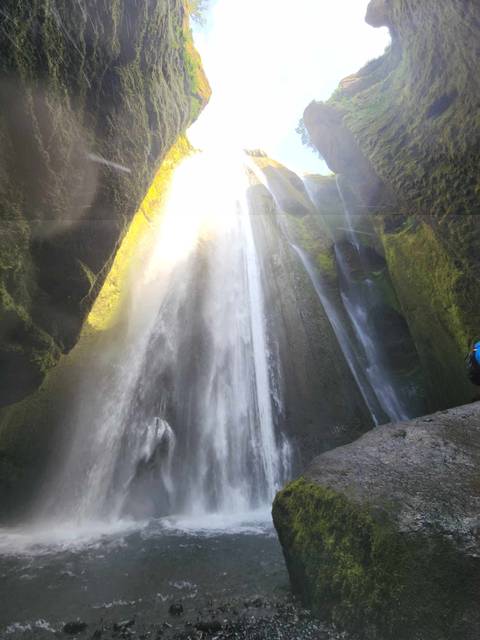 Waterfall cascading down rocky cliffs.