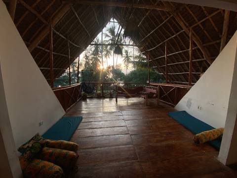       Open attic room with a view of palm trees
  