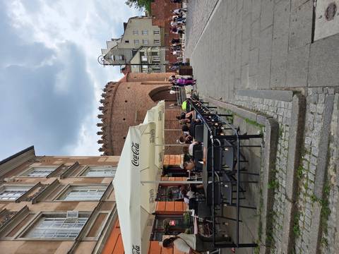       Outdoor cafe near a historical wall
  