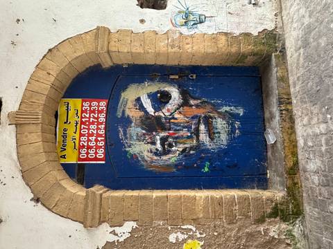       Painted blue door with colorful graffiti
  