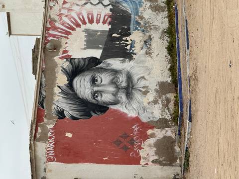       Street art of an elderly man with a long beard
  