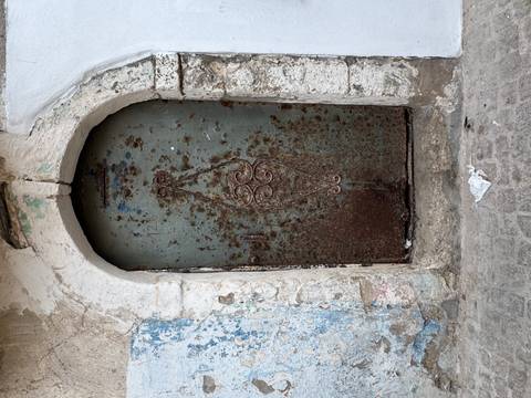       Old metal door in a stone wall
  