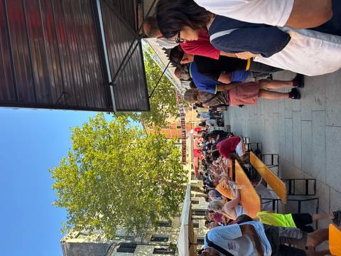 Dining festival with people seated at long tables.