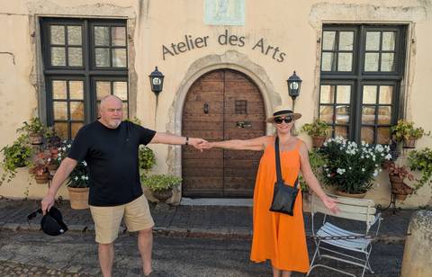       Couple posing in front of an art atelier
  