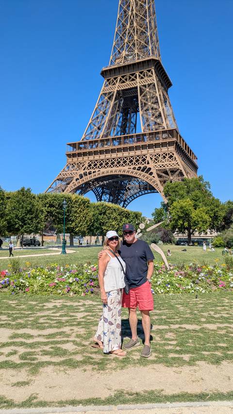       Couple in front of the Eiffel Tower during a sunny day
  