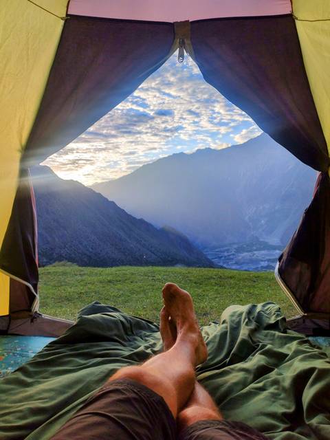 Mountain view from a tent opening at sunrise