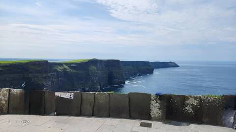       Cliffs overlooking the sea with cloudy skies.
  