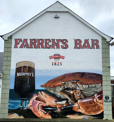       Building with a mural of a crab and beer advertisement.
  