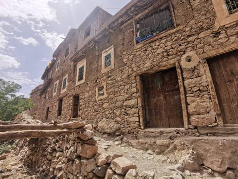 Rustic stone buildings on a hillside.