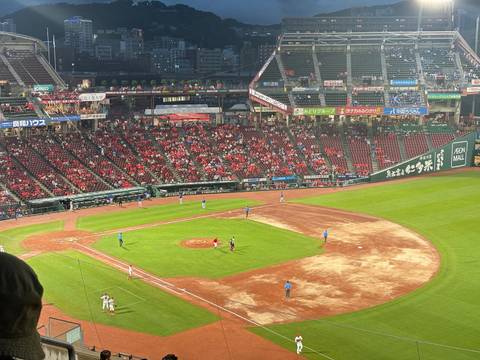       Baseball game with a stadium filled with spectators.
  