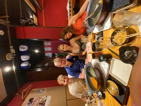       Family enjoying a meal together in a restaurant.
  