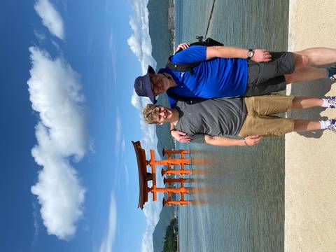       Two people posing in front of a famous water gate.
  