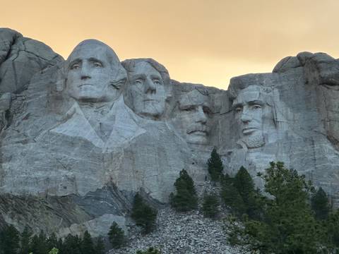       Mount Rushmore National Memorial with four presidents carved into the mountain.
  