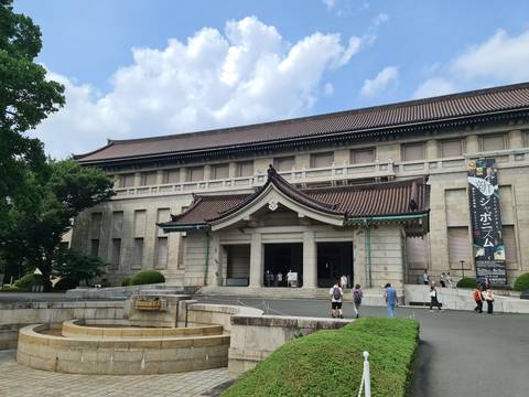       A historic museum building with people outside.
  