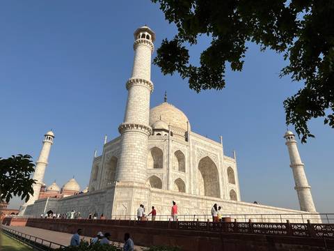 Side view of the Taj Mahal with its reflection on the water.