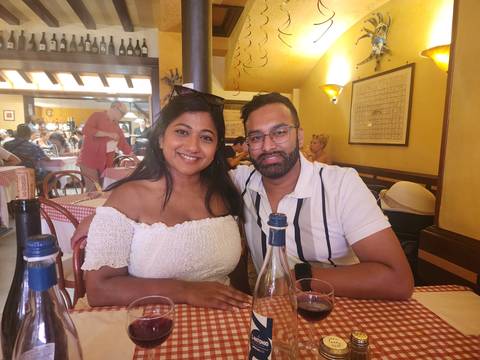      Couple enjoying meal in a cozy restaurant setting.
  