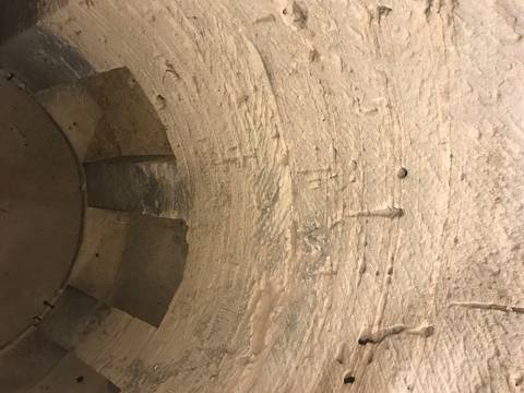       Interior view of a stone structure with a circular opening.
  