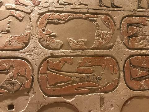       Close-up of ancient inscriptions on a stone surface.
  