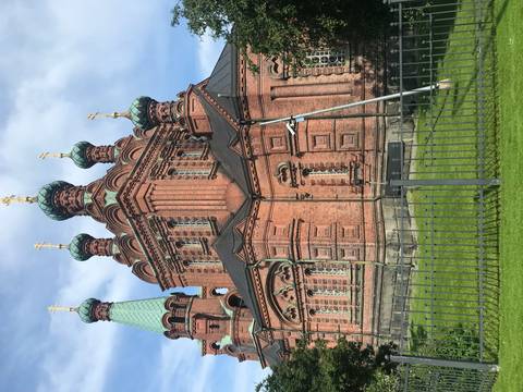      Orthodox church with prominent domes and intricate brickwork.
  