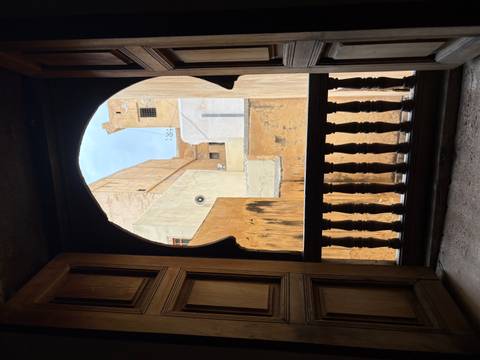       View through a decorative window of a traditional building.
  