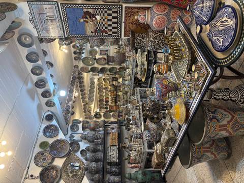Shop filled with colorful traditional pottery and decoration plates.