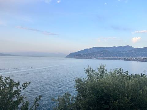 Scenic view of the coastline with distant mountains.