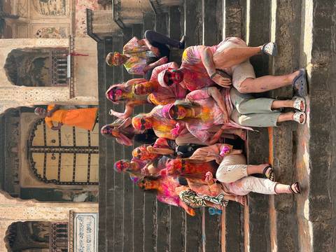 Group of people celebrating Holi with colorful powder.