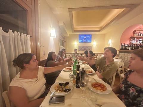 Group of people indoors celebrating around a dinner table.