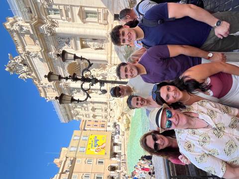       Group of people in front of a fountain
  