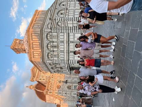       Group of people posing in front of the Florence Cathedral
  