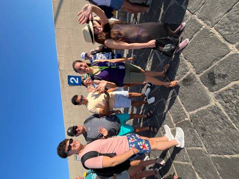 Group of people on a street with a number sign