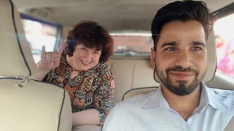 Two people taking a selfie in a car